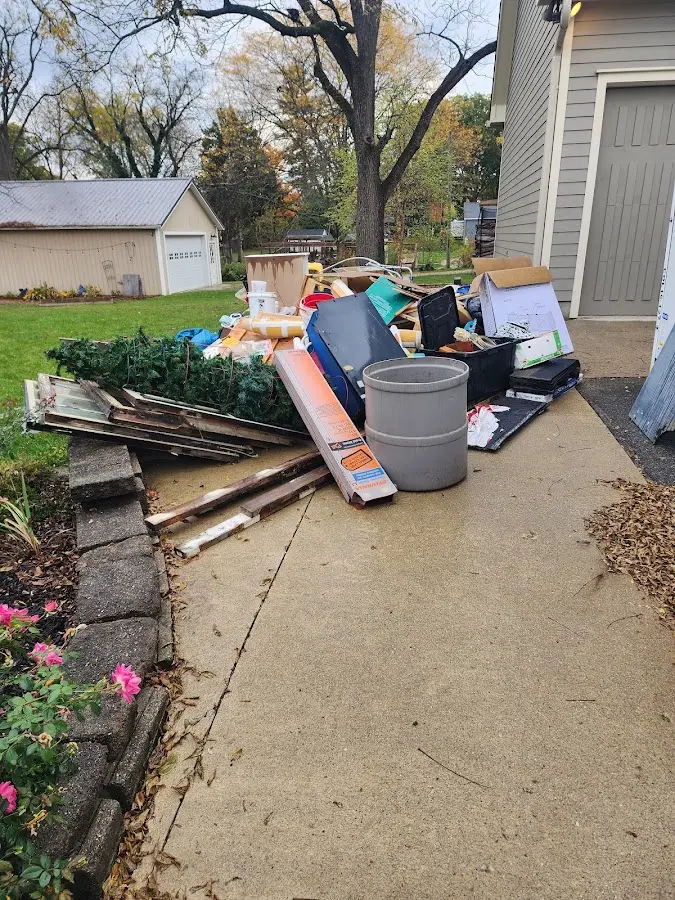 Dumpster being loaded with debris for Estate Cleanout Dumpster Rental in Pequannock